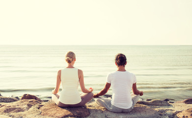 Fototapeta premium couple making yoga exercises outdoors