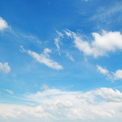 Naklejka na ściany i meble fluffy clouds in the blue sky