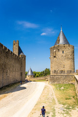 Fototapeta na wymiar Carcassonne, France. The walls and towers of the double row of fortifications. Fortress is included in the UNESCO World Heritage List