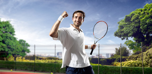 Young man is playing tennis - obrazy, fototapety, plakaty