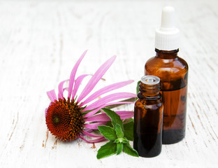  bottles with essence oil with purple echinacea - obrazy, fototapety, plakaty