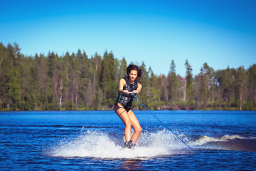 Young woman study riding wakeboarding on a lake