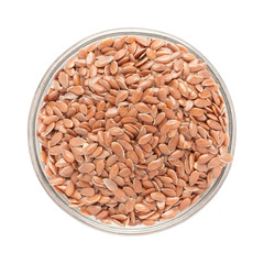 Top view of Organic Linseed or Flaxseed (Linum usitatissimum) in glass bowl isolated on white background.