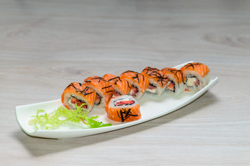 Close-up of a white plate with sushi set -  salmon with strawber