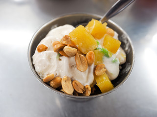 Ice cream sprinkled with peanuts and coconut milk it.