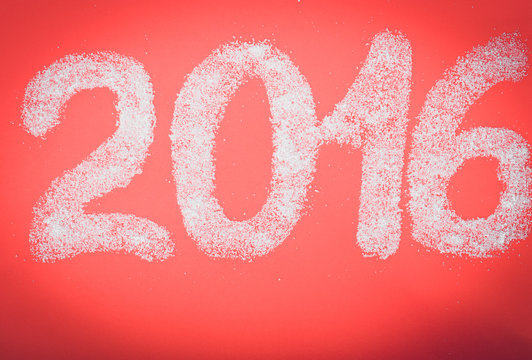 Sugar in the form of numbers 2016 red paper background. Christma