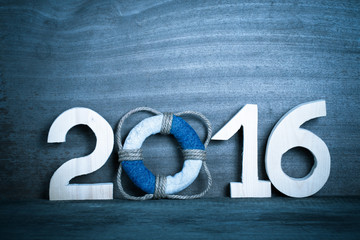 Lifebuoy instead of the digit 0 in the number 2016 on gray woode