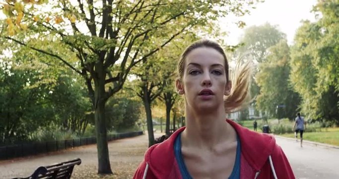 Runner woman running in park exercising outdoors