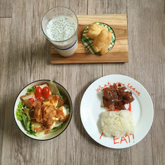 top view of breakfast. Sweet pork and sticky rice, egg salad, and deep fried doughstick on wooden table