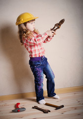 little girl plays in the builder