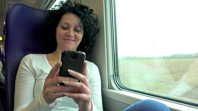 4k Young Happy Woman Texting with Cell phone While Traveling by Train. UHD stock footage