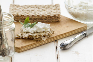 Crispbread with cheese on a vintage wooden background
