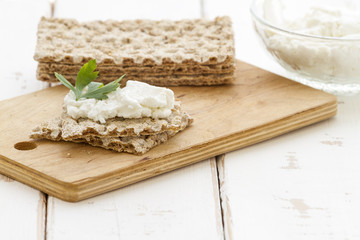 Crispbread with cheese on a vintage wooden background

