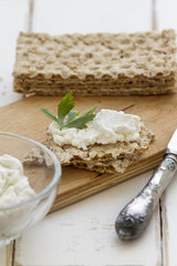 Crispbread with cheese on a vintage wooden background
