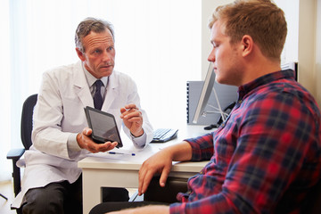 Patient Having Consultation With Male Doctor In Office