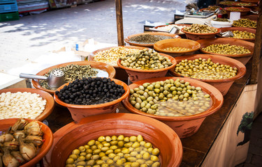 Different marinated olives and local food on spanish street mark