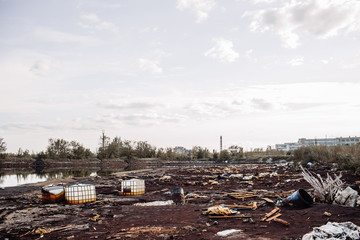 toxic containers and garbage lying on chemical contaminated wast