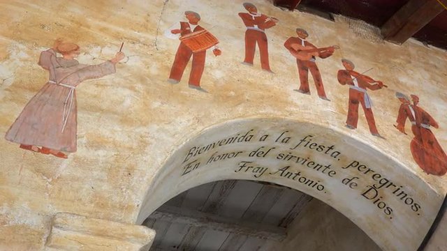 Murals line the adobe walls of a California Mission.