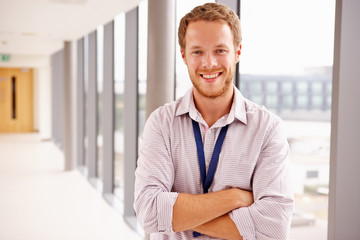 Portrait Of Male Doctor Standing In Hospital Corridor