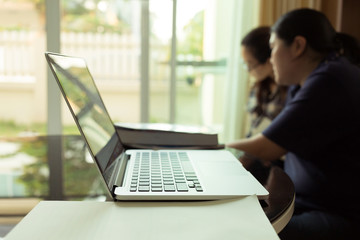 people using laptop working in living room home office