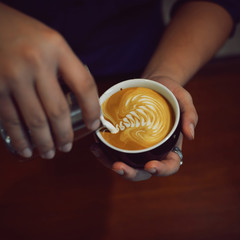 cup of latte art coffee in vintage color tone