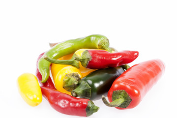 heap of colorful raw chili pepper on white background