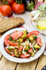 Warm autumn salad with eggplant, tomato, onion
