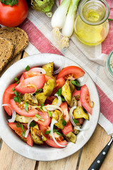 Warm autumn salad with eggplant, tomato, onion