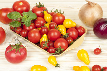 yellow and red tomatoes on wooden table