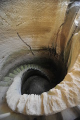 Underground passage in the cave with a spiral stone stairs 