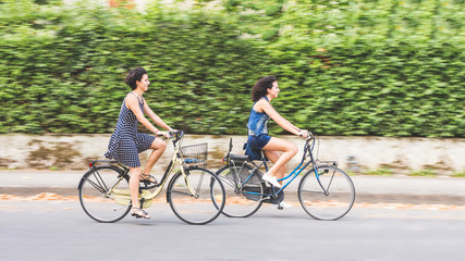 Fototapeta premium A couple of friends with bikes, motion blur.