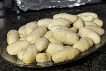 Meat croquettes in oval dish before being breaded. Cooking