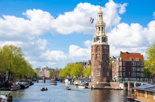 Amsterdam cityscape and the Montelbaanstoren tower on the left. The canal Oudeschans, the Netherlands.