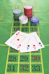 Four aces and poker rooms on green carpet with numbers drawn