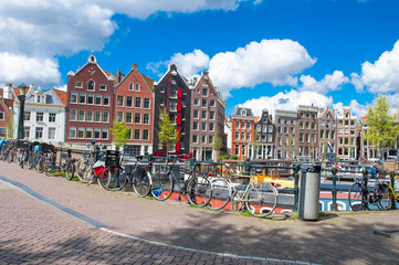 Amsterdam, the Netherlands-April 27: Traditional Amsterdam cityscape with apartment houses in the distance on April 27,2015. Amsterdam is the most populous city of the Kingdom of the Netherlands.