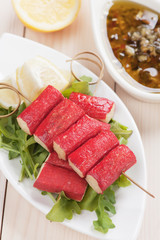 Crab sticks with lemon and rocket salad