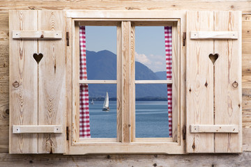 Wooden window with a lake as reflections