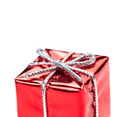 Fototapeta premium Red gift box with silver ribbon and bow isolated on white macro