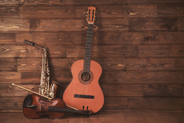 Fototapeta na wymiar Musical instruments on wooden planks background
