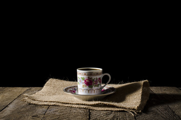 Porcelain coffee cup on wooden table