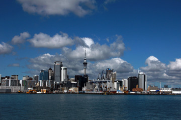 Fototapeta premium Auckland, New Zealand - the largest and most populous urban area in the country, view of the city from the water on a bright sunny day with cumulus clouds in the sky