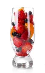 Fresh fruits salad in glass isolated on white
