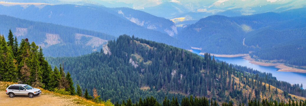 romania.bucegi mountains.SUV off road adventure.Panoramic view of the Bucegi mountains, the forest and lake Bolboci, a wild, unexplored area, which can be reached only with a SUV