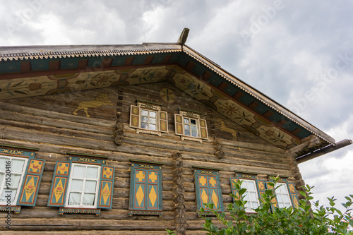 Example Of Traditional Log House With Painted Details On Eaves