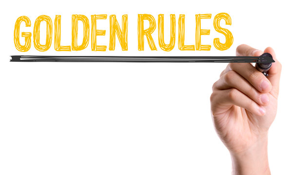 Hand with marker writing: Golden Rules