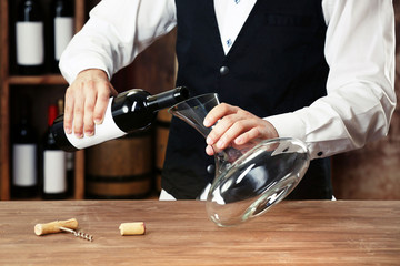 Bartender working at counter on bar background