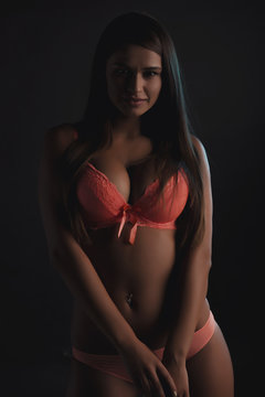 Slim woman in lingerie posing in the shadows
