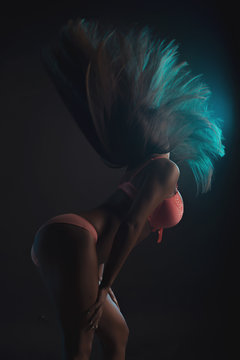 Slim woman in lingerie posing in the shadows