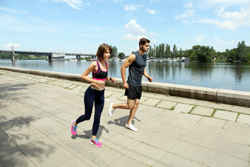 Young people jogging near river