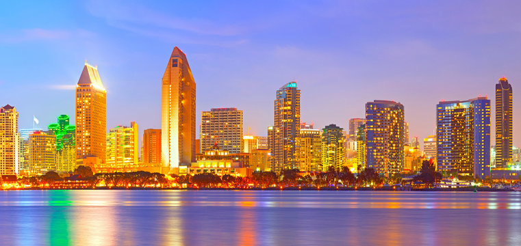 San Diego California, city skyline at sunset on a beautiful summer night with lighted skyscrapers and downtown buildings